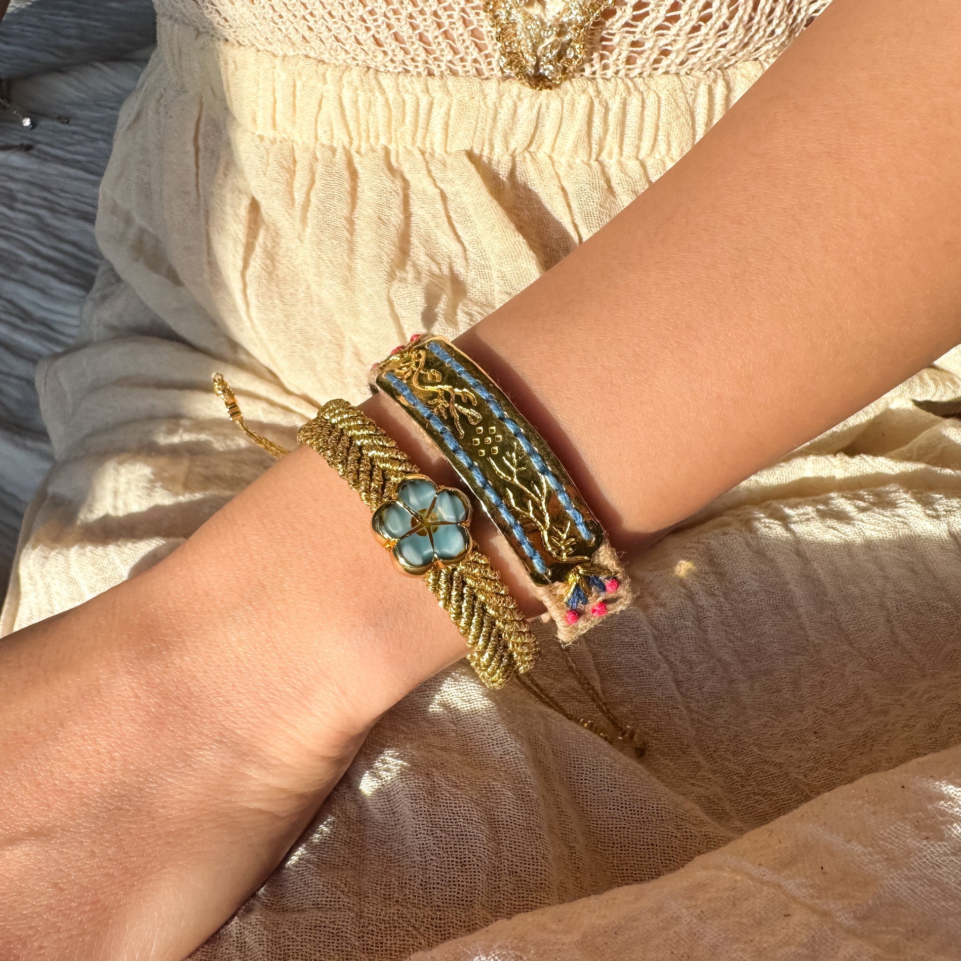 Close-up of a wrist wearing multiple bracelets with intricate designs.