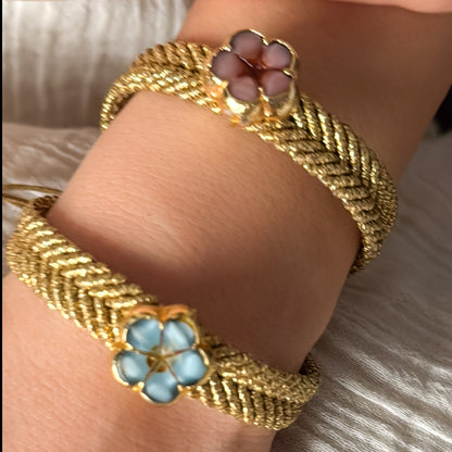 Gold bracelets with floral designs 